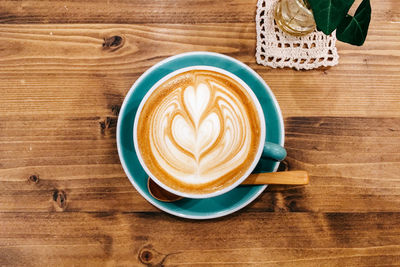 Directly above shot of cappuccino on wooden table