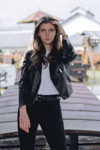 Portrait of beautiful young woman standing outdoors