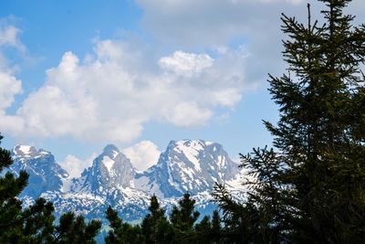 Low angle view of snowcapped mountains against sky