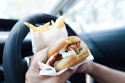 Cropped hand of person holding food