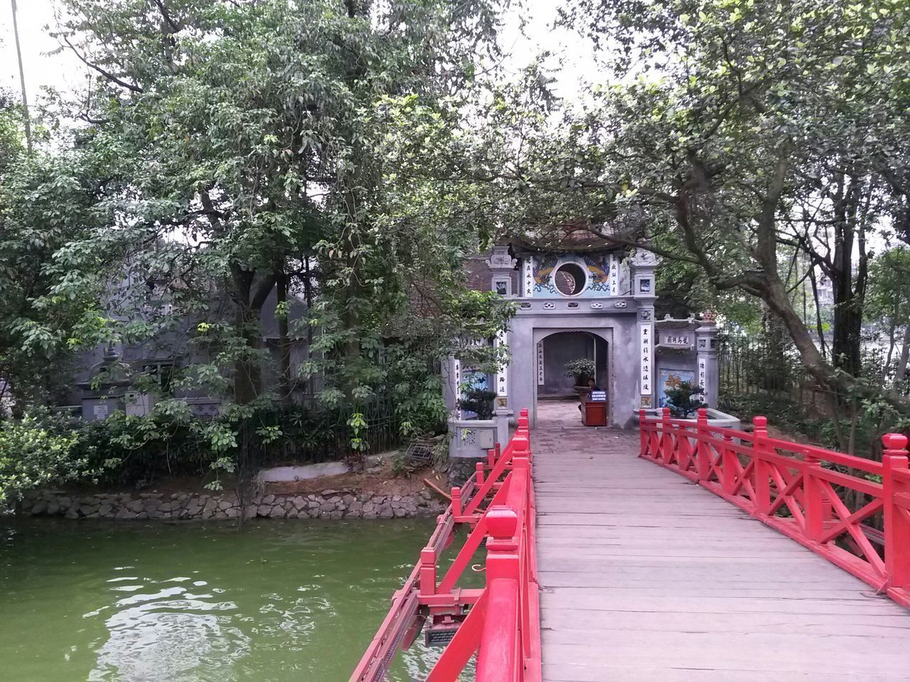 BRIDGE OVER CANAL AGAINST TREES