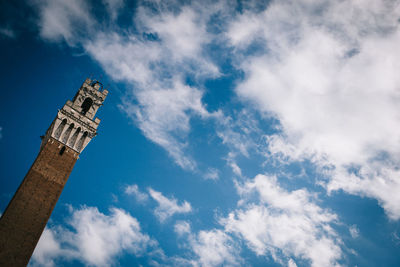 Low angle view of torre del mangia against sky