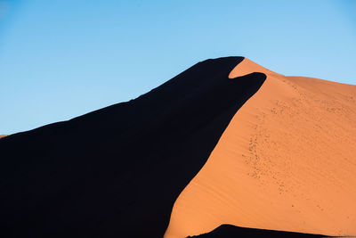 Scenic view of desert against clear sky