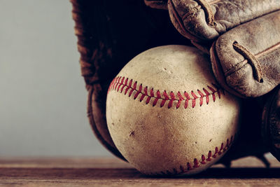 Close-up of baseball glove and ball on table