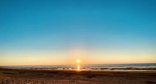 Scenic view of sea against clear sky during sunset