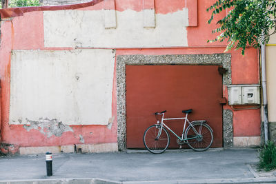 Bicycle leaning on wall in city