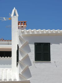 Low angle view of house against clear blue sky