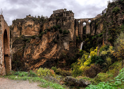 Low angle view of old ruin building against cloudy sky