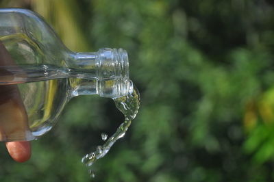 Close-up of hand holding glass of water