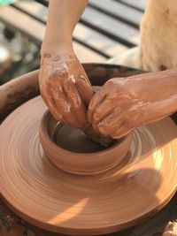 Cropped image of man making pottery at workshop