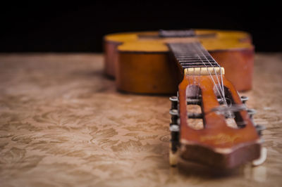 Close-up of guitar on table