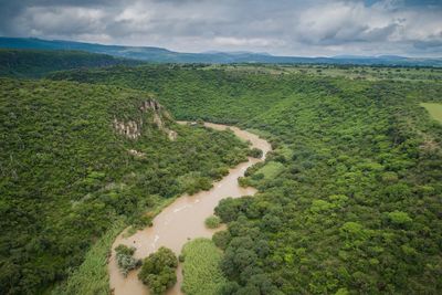 High angle view of river amidst landscape against sky