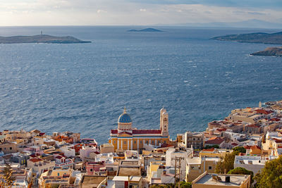 High angle view of townscape by sea against sky