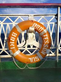 Close-up of orange text on metal chain