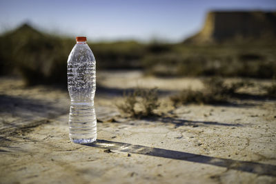 Close-up of light bulb on dirt road