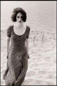 Portrait of young woman standing on beach