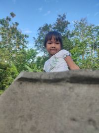 Portrait of cute girl against sky
