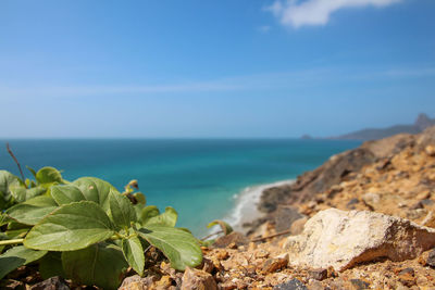 Rocks by sea against sky