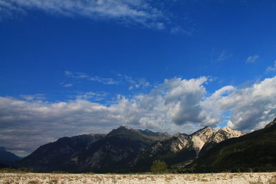 Scenic view of mountains against blue sky