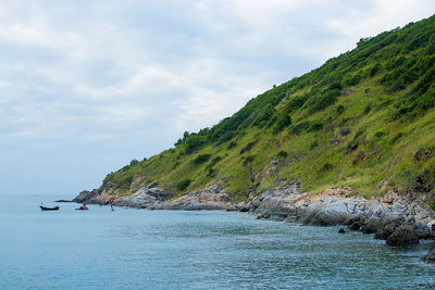 Scenic view of sea and mountains against sky