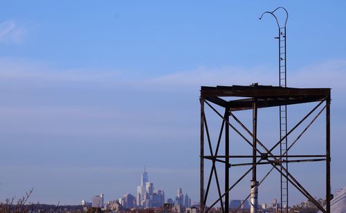 Tower in city against blue sky