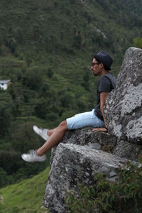 Side view of man standing on rock