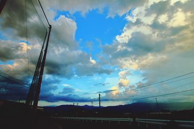 Low angle view of electricity pylon against sky