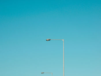 Low angle view of street lights against clear sky