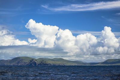 Scenic view of sea and mountains against sky