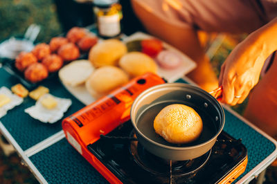 Cropped hand of woman preparing food