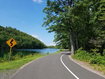 Empty road along countryside lake