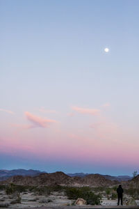 Scenic view of landscape against clear sky at sunset