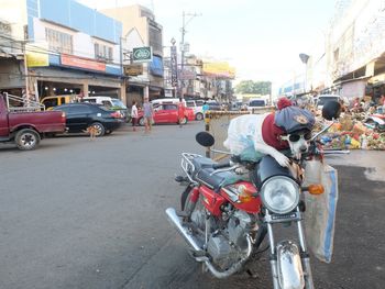 Vehicles on road against buildings