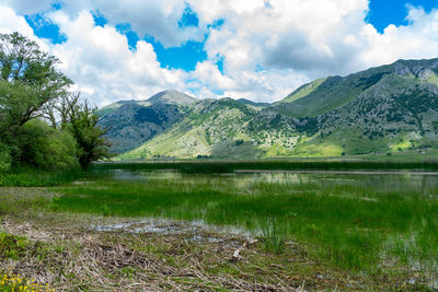 Scenic view of lake and mountains against sky