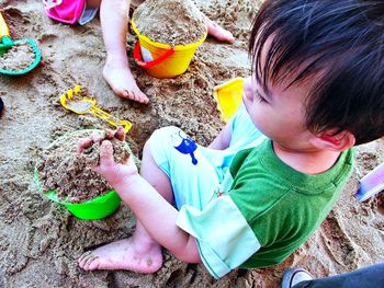 High angle view of children playing with toy