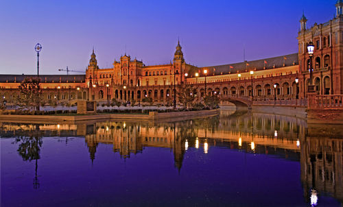 Reflection of building in water at night