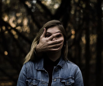 Portrait of young woman in forest