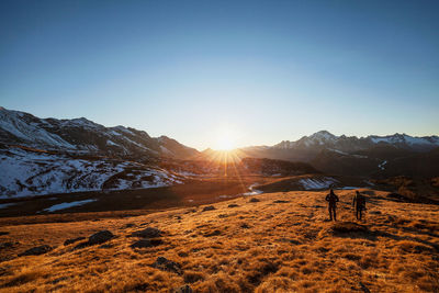 Scenic view of snowcapped mountains against clear sky