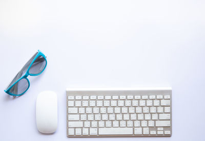 Close-up of mobile phone on table against white background