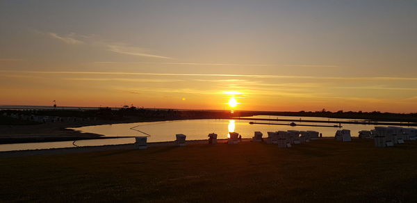 Scenic view of river against sky during sunset