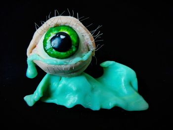 Close-up of a stuffed toy over black background