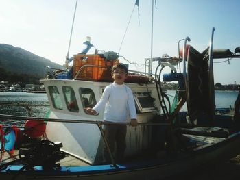 Woman looking at boat in sea