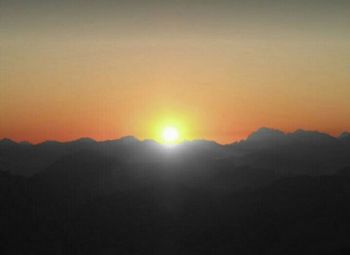 Scenic view of silhouette mountains against sky during sunset