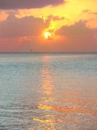 Scenic view of sea against orange sky