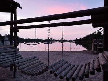 Bridge over river against sky during sunset