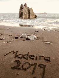 Madeira text writing in sand of beach 