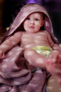 Portrait of cute baby wrapped in towel