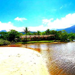 Scenic view of river against cloudy sky