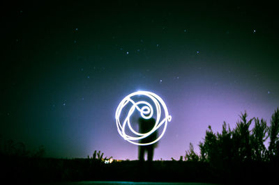 Illuminated ferris wheel at night