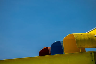 Hay bales on field against blue sky